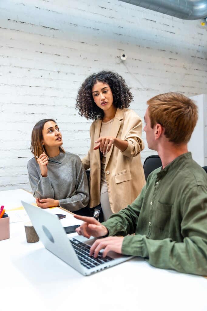 Boss scolding two employees in a coworking space